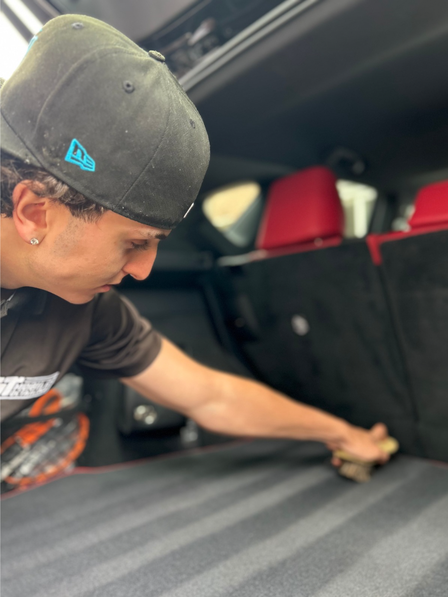 A GT team member detailing the interior of a client vehicle