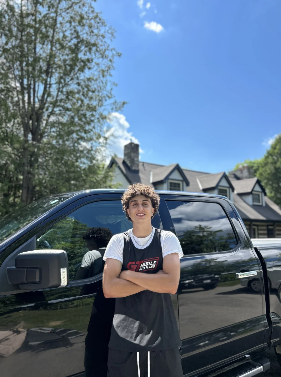 Marco Amoroso, Operations Manager at GT Commercial Cleaning, standing beside a detailed truck