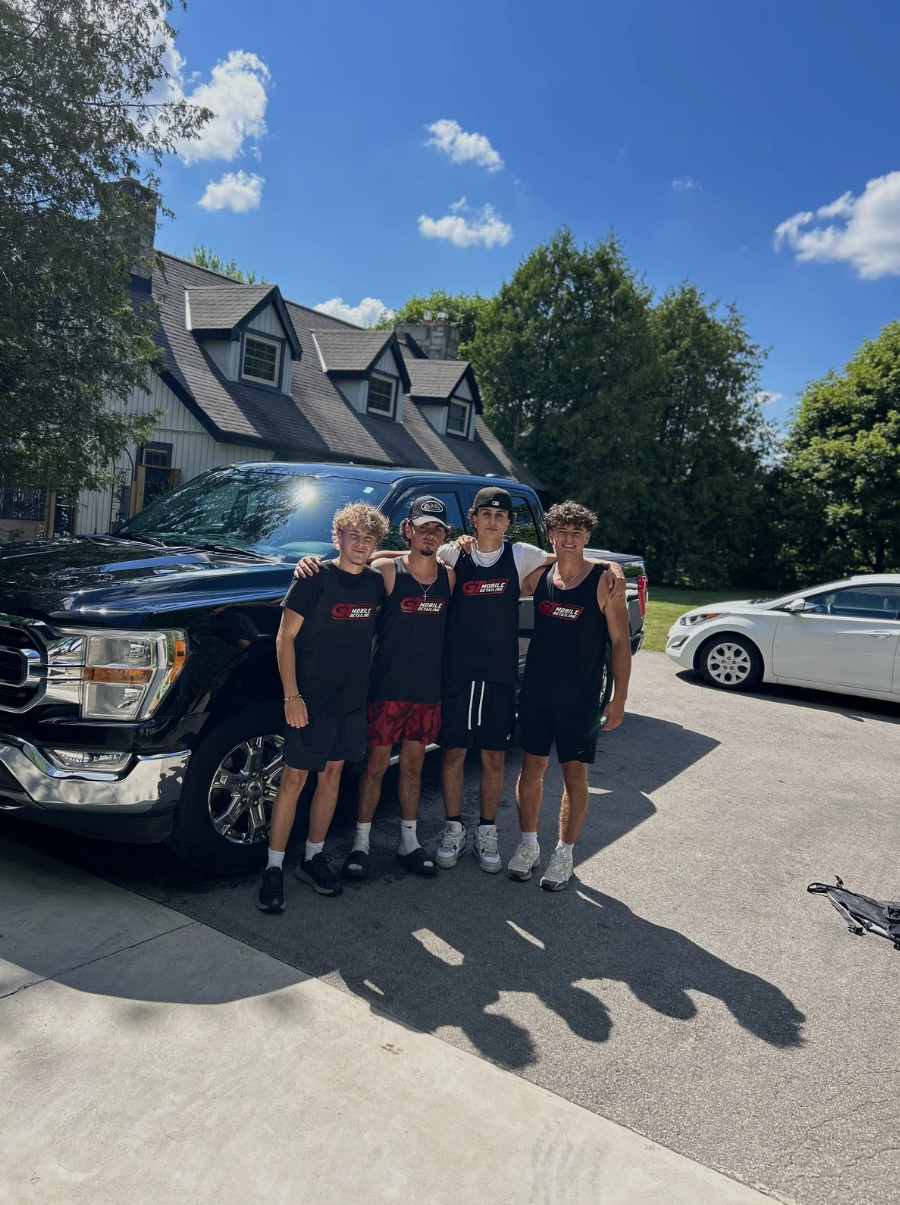 The GT crew in uniform in front of a black truck in Halton Hills